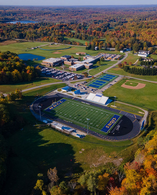 An aerial view of the campus with the football field in the center